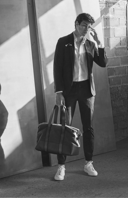 NYC fashion photographer director Hunter and Gatti Massimo Dutti Man standing with bag black and white